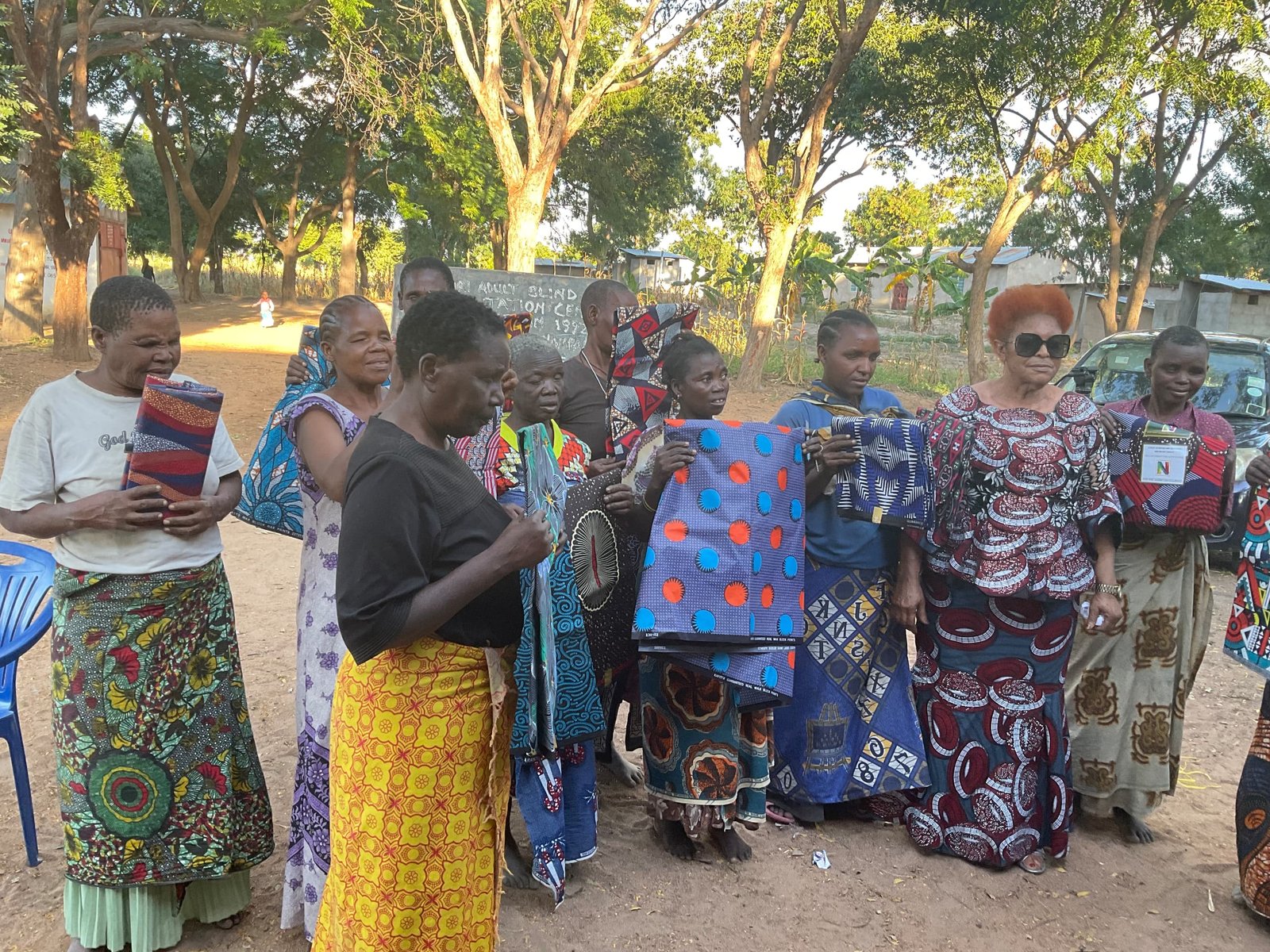 Community members holding donated fabrics