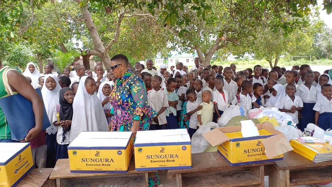 Foundation volunteers with schoolchildren and exercise books