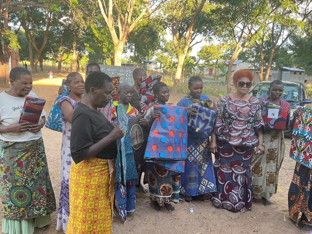 Women's group holding donated fabrics