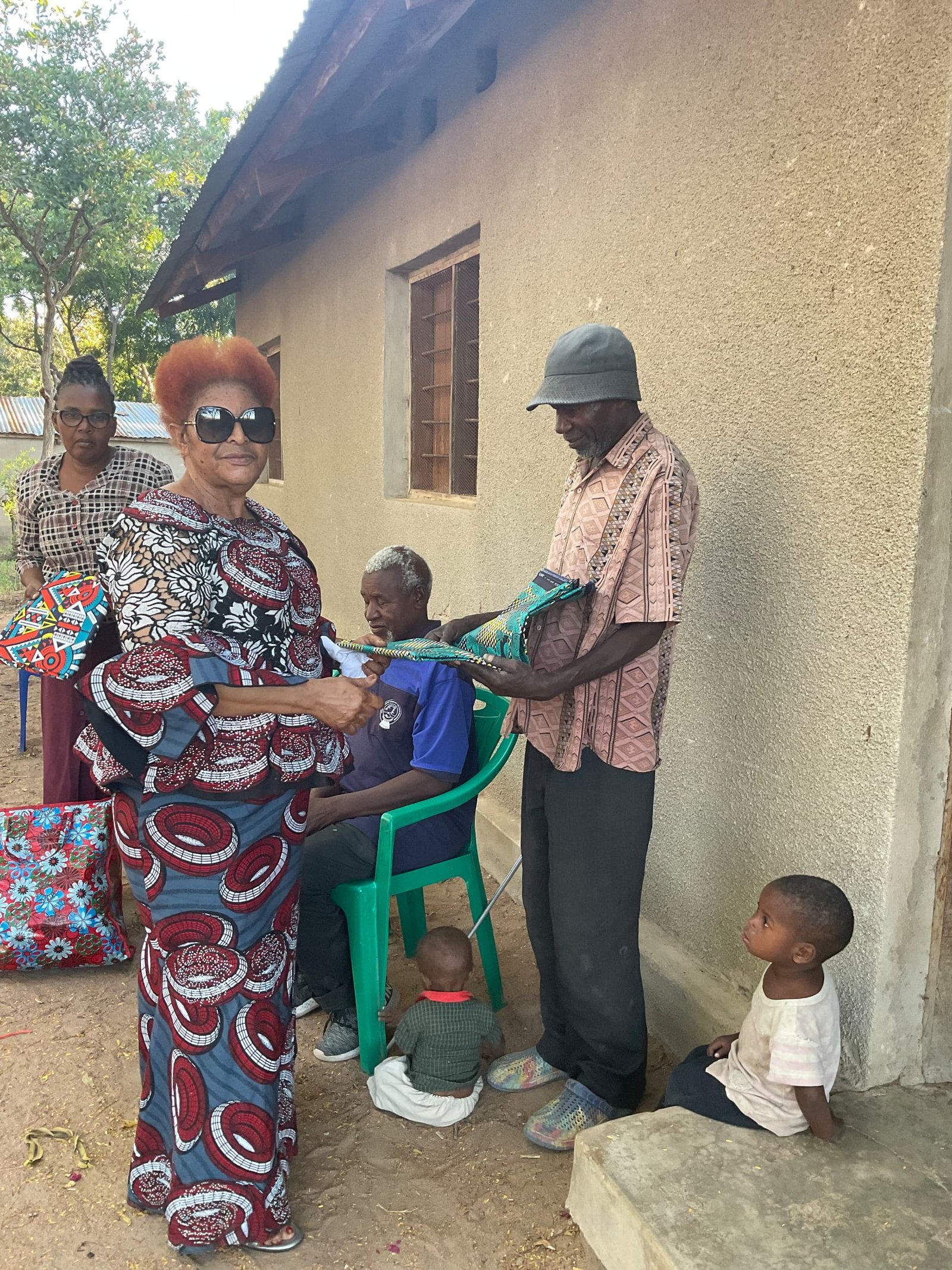 Handing clothing to community elders